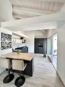 a kitchen with a wooden table and chairs at Terme Apartment Levico in Levico Terme