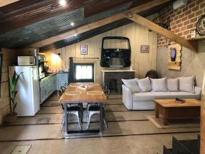 a living room with a couch and a table at La Garçonnière in Champigny-lès-Langres
