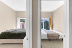 a bedroom with a bed and a mirror at Charming 2BR Bkyrd Near Williamsburg in Brooklyn