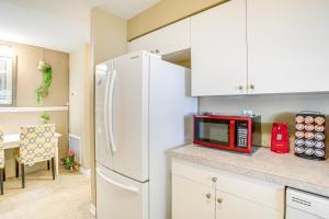 a kitchen with a white refrigerator and a red microwave at 5 Mi to Beach Family-Friendly Home in Clearwater! in Clearwater +19 photos
