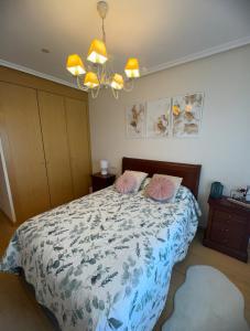 a bedroom with a bed with two pillows on it at Habitaciones De Lujo Con Hermosas Vistas A La Cuidad in Burgos