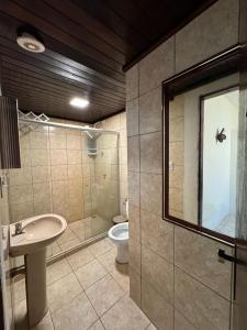a bathroom with a sink and a toilet at Pousada Flor de Porto in Porto De Galinhas