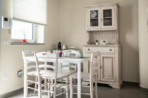 a kitchen with a white table and chairs at B&B Sweet Home - Cilento in Agropoli
