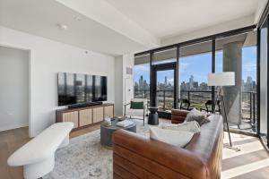 a living room with a couch and a large window at Coffe bar + spa + Lounge + Golf at Lincoln Park-1475-By Cloud9 in Chicago