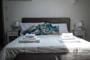 a bed with towels and pillows on it at B&B Sweet Home - Cilento in Agropoli