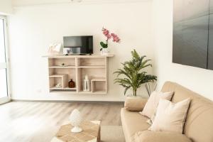 a living room with a couch and a tv at B&B Sweet Home - Cilento in Agropoli