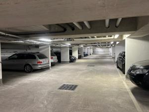 a parking garage with several cars parked in it at 5 mn Stade de France in Saint-Denis
