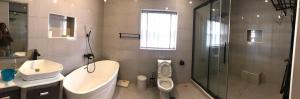 a bathroom with a sink toilet and a shower at Portland Residence in Lekki