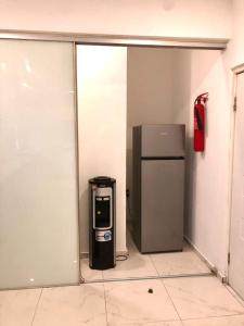a room with a refrigerator and a trash can at Portland Residence in Lekki