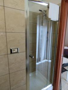 a shower with a glass door in a bathroom at Valle Dei Templi Rent BedRooms in Agrigento +71 photos