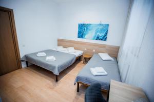 a room with two beds and a table at Staryi Krakiv in Lviv