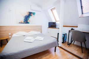 1 dormitorio con 1 cama con 2 toallas en Staryi Krakiv, en Leópolis