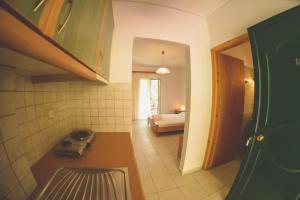 a room with a kitchen and a bedroom with a bed at Althea Studios Lefkada in Agios Nikitas +42 photos