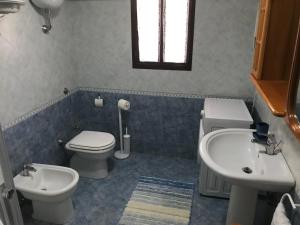 a bathroom with a toilet and a sink at Villa "Ma Mi" Carloforte in Carloforte +5 photos