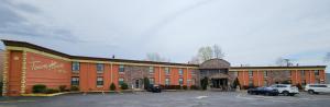 a hotel with cars parked in a parking lot at Town House Inn and Suites in Elmwood Park