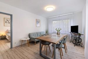 a living room with a dining room table and chairs at Apartment Alb Glück 2 in Hechingen