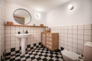 a bathroom with a sink and a toilet and a mirror at Traditional Anna's Stone House with Private Pool in Margarítai