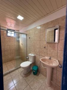 a bathroom with a toilet and a sink at Pousada Flor de Porto in Porto De Galinhas