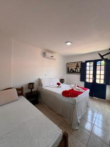 a bedroom with two beds in a room at Pousada Flor de Porto in Porto De Galinhas