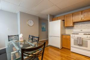 a kitchen with a table and a white refrigerator at Central 3 Bed 1 Bath in Historic Building in Boston