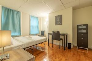 a hospital room with a bed and a desk at Central 3 Bed 1 Bath in Historic Building in Boston