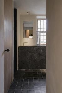 a bathroom with a sink and a mirror at Loggia Studio in Edinburgh