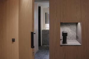 a door to a bathroom with a shower and a sink at Loggia Studio in Edinburgh