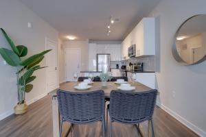 a kitchen and dining room with a table and chairs at Quiet Apartment with Amazing Amenities @Alexandria in Alexandria