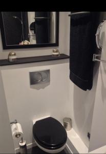 a bathroom with a black toilet and a mirror at FANTASTIC OCEAN VIEW in Biarritz