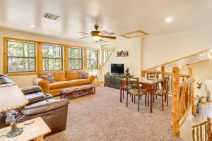 a living room with a couch and a table at Rustic Lakeside Cabin on 3 Acres w/ Nature Views! in Pinetop-Lakeside