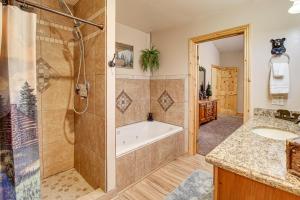 a bathroom with a tub and a shower and a sink at Rustic Lakeside Cabin on 3 Acres w/ Nature Views! in Pinetop-Lakeside +27 photos