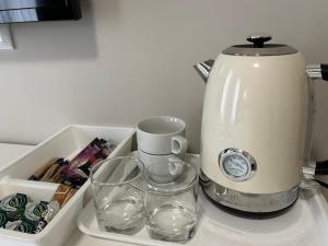 a coffee maker and glasses sitting on a counter at New House 2 in Sibiu