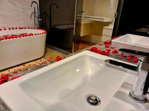 a white sink in a bathroom with a mirror at The Platinum KLCC By Staycation in Kuala Lumpur