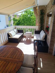 a patio with a couch and a table on a deck at Apartamento Caravaca in Santa Pola
