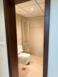 a bathroom with a toilet and a shower at 1 BHK in Al Khan Sharjah in Sharjah