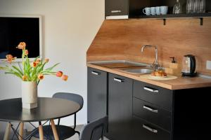 a small kitchen with a sink and a table at Cozy apartment Sunny Beach in Sunny Beach +19 photos