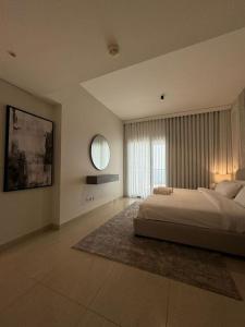 a large bedroom with a bed and a window at Damac Tower Jeddah apartment in Jeddah