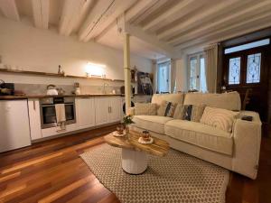 a living room with a couch and a table at LES SEYCHELLES, T2, Hyper Centre, Cours intérieure in Mâcon