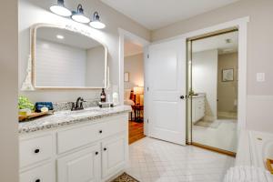 a bathroom with a sink and a mirror at Sunset Paradise on Weiss Lake with Private Dock! in Centre +24 photos