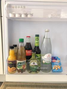 a refrigerator filled with bottles of food and drinks at Ferienwohnung Alex in Kirchenlamitz