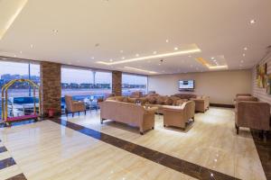 a large waiting room with couches and a slide at Burj Alhayah Alfalah in Riyadh