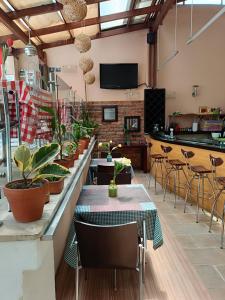 a restaurant with tables and chairs with plants on them at HBCF Hotel Boutique Casa Farallones de Santiago de Cali in Cali