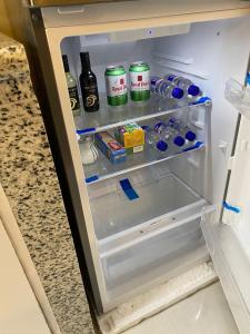an open refrigerator filled with food and drinks at Hermosa suite 2 cerca de todo in Guayaquil