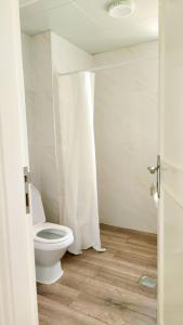 a bathroom with a white toilet in a room at Ms. Zhang's Flat 303 in Abu Dhabi