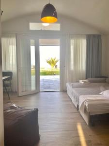 a bedroom with a bed and a sliding glass door at Ocean Sun 4 in Fira