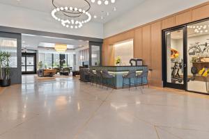a lobby with a bar with stools at Coffe bar + spa + Lounge + Golf at Lincoln Park-1475-By Cloud9 in Chicago