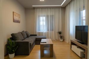a living room with a couch and a table at Dimitra Rooms in Litochoro