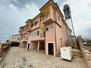 a building is being constructed with a crane at CasaCasa Apartments in Enugu