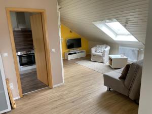 a living room with a skylight and a couch and a television at Ferienwohnung Salem-Beuren in Beuren