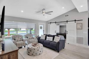 a living room with a couch and two chairs at Near Beach/kayaks/HtdPool/Tiki/BBQ/Gameroom in Pompano Beach